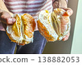 Close up on a man's hands holding the two halves of a large, ripe, peeled orange. The juicy segments and seeds are visible. High quality photo 138882053
