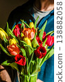 Close up of a person holding a beautiful bouquet of fresh red and yellow tulips. A perfect gift for spring, Mothers day, or a birthday.High quality photo 138882058
