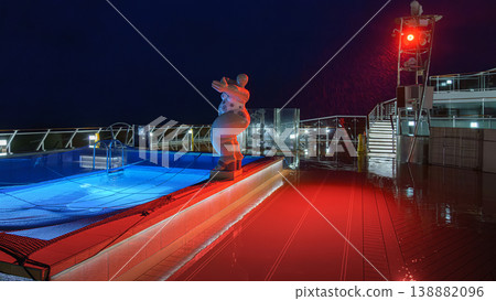 Muroran, Hokkaido, Japan - Oct 04 2024, panoramic view of pool decorated with a sculpture of a plump woman in a swimsuit, on upper deck of the MSC Bellissima cruise ship, at night, Muroran, Japan 138882096