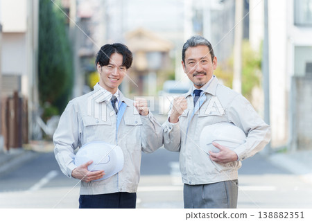 Workers posing in celebration outdoors Workers posing in celebration outdoors 138882351