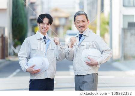 Workers posing in celebration outdoors Workers posing in celebration outdoors 138882352