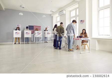 Diverse group of people registering at polling station standing in a queue at vote center Diverse group of people registering at polling station standing in a queue at vote center 138882614