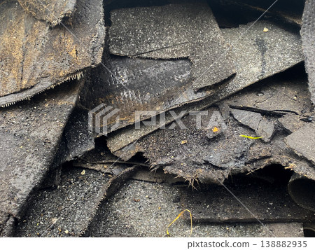 Old roofing materials are stacked in a construction area during midday work hours Old roofing materials are stacked in a construction area during midday work hours 138882935