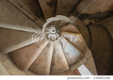 The spiral staircase inside the Sagrada Familia, the stone steps that evoke a sense of history. 138883266