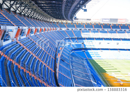 The vibrant scenery inside the stadium, with its expansive blue stands of the Estadio Santiago Bernabéu. The vibrant scenery inside the stadium, with its expansive blue stands of the Estadio Santiago Bernabéu. 138883316