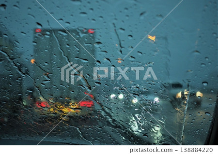 The car window was filled with a torrential downpour so heavy it obscured the view. The car window was filled with a torrential downpour so heavy it obscured the view. 138884220