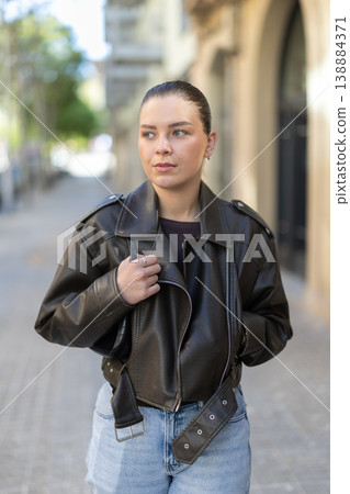 Young woman walks along city street Young woman walks along city street 138884371