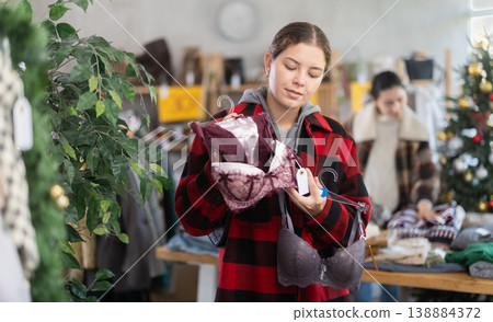 Uncertain young girl choosing bra in clothing store 138884372