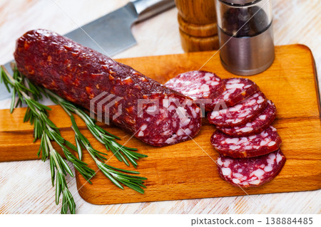 Tasty dried semi-dry sausage Braunschweig with rosemary 138884485