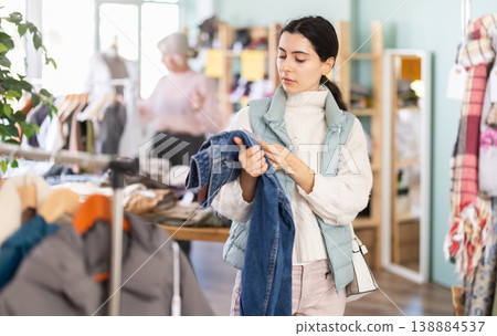 Regular customer Armenian woman chooses color and style of jeans trousers Regular customer Armenian woman chooses color and style of jeans trousers 138884537