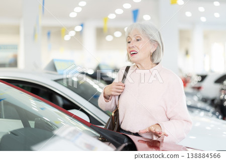 Elderly woman choosing car at auto dealership 138884566