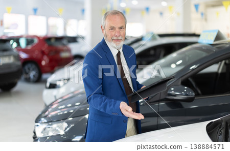 Elderly successful car salesman offers to buy a car at car dealership Elderly successful car salesman offers to buy a car at car dealership 138884571
