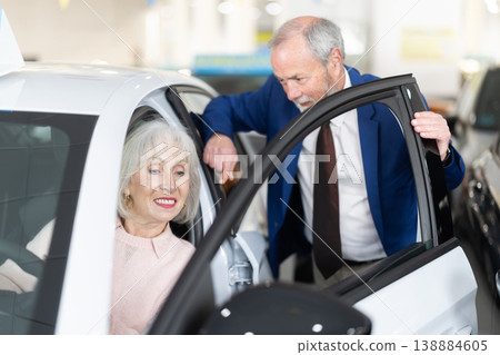 Mature couple choosing car at auto dealership 138884605