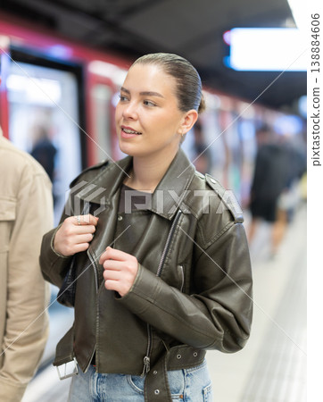 Pretty girl walks along the platform waiting for subway train Pretty girl walks along the platform waiting for subway train 138884606