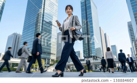 A businesswoman confidently walking through the business district. 138884607