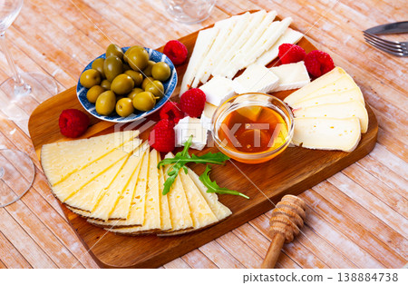 Cheese plate with raspberry and olives 138884738