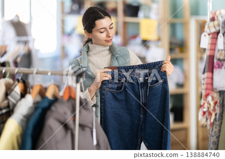 Regular customer Armenian woman chooses color and style of jeans trousers Regular customer Armenian woman chooses color and style of jeans trousers 138884740