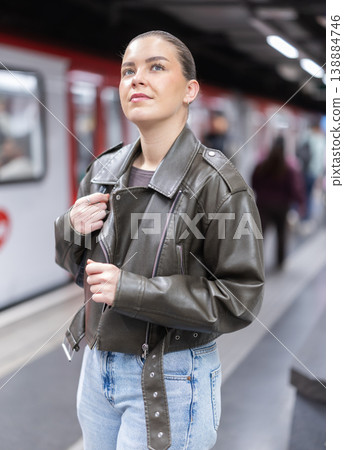 Young woman standing at metro station Young woman standing at metro station 138884746