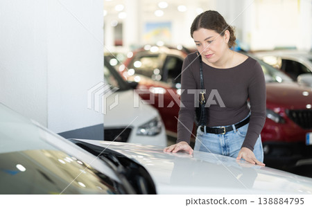 woman choosing a car in a car dealership 138884795