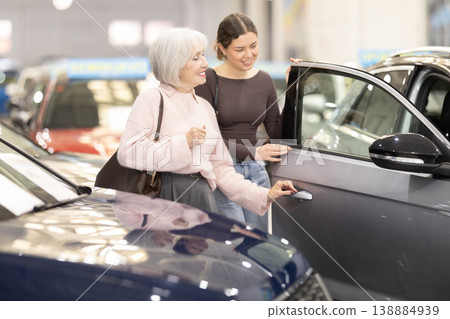 Young and elderly woman choosing car at dealership 138884939