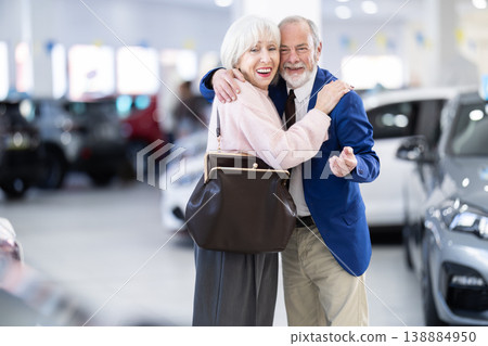 Elderly couple chooses new car together at car dealership Elderly couple chooses new car together at car dealership 138884950