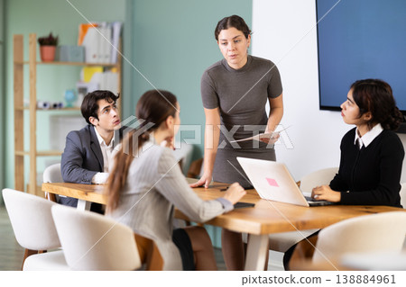 Young woman leading meeting at office table Young woman leading meeting at office table 138884961