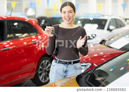 Young woman is happy to buy a car, she keeps the keys Young woman is happy to buy a car, she keeps the keys 138885082