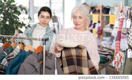 Elderly and young woman choosing coat or down jacket 138885085