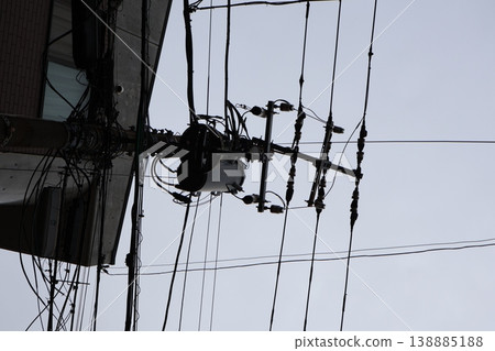A quiet afternoon in a cloudy townscape with towering utility poles (6) 138885188