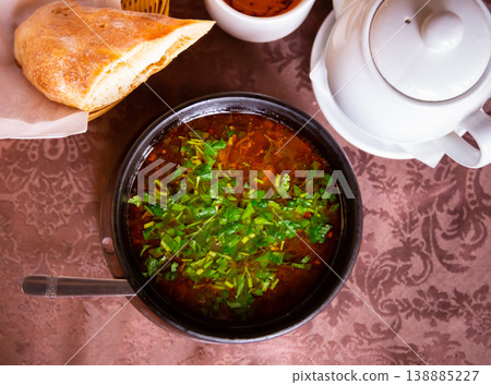 Georgian kharcho soup with lamb garnished with fresh greens Georgian kharcho soup with lamb garnished with fresh greens 138885227