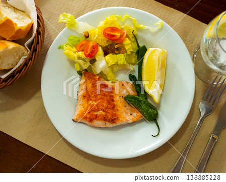 Roasted salmon steak with a light vegetable salad 138885228