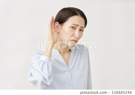 Hearing-impaired woman in her 40s on white background 138885248