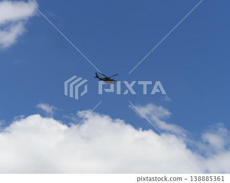 A U.S. Army UH-60A Black Hawk flies over Osaka City. A U.S. Army UH-60A Black Hawk flies over Osaka City. 138885361