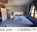 A Cozy Bedroom Interior that Features Modern Decor and Abundant Natural Light Throughout the Space 138886270