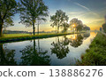 A colorful sunrise reflection over a tranquil canal captivates viewers with beauty and harmony 138886276