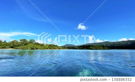 The breathtaking scenery of Kabira Bay in Ishigaki Island: the incredibly blue sea and sky, glass-bottom boat tour, Okinawa. The breathtaking scenery of Kabira Bay in Ishigaki Island: the incredibly blue sea and sky, glass-bottom boat tour, Okinawa. 138886352