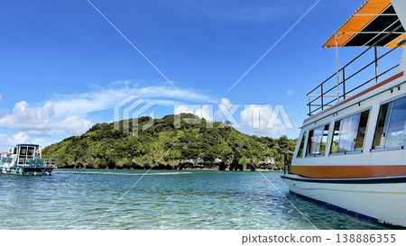 The breathtaking scenery of Kabira Bay in Ishigaki Island: the incredibly blue sea and sky, glass-bottom boat tour, Okinawa. The breathtaking scenery of Kabira Bay in Ishigaki Island: the incredibly blue sea and sky, glass-bottom boat tour, Okinawa. 138886355