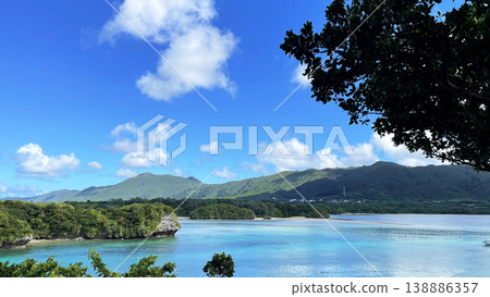 The breathtaking scenery of Kabira Bay in Ishigaki Island: the incredibly blue sea and sky, glass-bottom boat tour, Okinawa. The breathtaking scenery of Kabira Bay in Ishigaki Island: the incredibly blue sea and sky, glass-bottom boat tour, Okinawa. 138886357