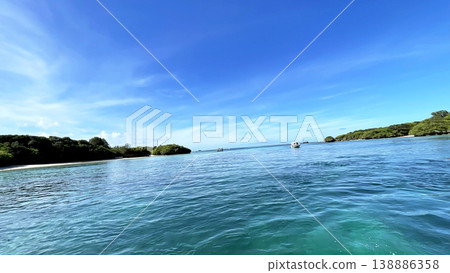 The breathtaking scenery of Kabira Bay in Ishigaki Island: the incredibly blue sea and sky, glass-bottom boat tour, Okinawa. The breathtaking scenery of Kabira Bay in Ishigaki Island: the incredibly blue sea and sky, glass-bottom boat tour, Okinawa. 138886358