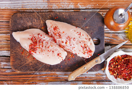 chicken breast with spice on wooden board chicken breast with spice on wooden board 138886850