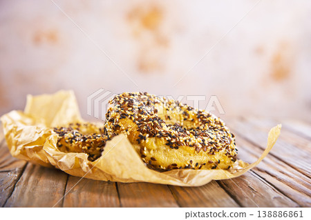Overhead view of freshly baked bagels a table, top view of homemade bagels on paper 138886861