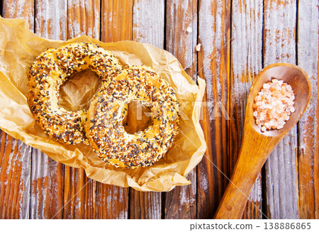 Overhead view of freshly baked bagels a table, top view of homemade bagels on paper Overhead view of freshly baked bagels a table, top view of homemade bagels on paper 138886865