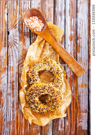 Overhead view of freshly baked bagels a table, top view of homemade bagels on paper Overhead view of freshly baked bagels a table, top view of homemade bagels on paper 138886866