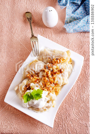 Dumplings with fried onions on white plate. Varenyky, vareniki, pierogi. Dumplings with fried onions on white plate. Varenyky, vareniki, pierogi. 138886902