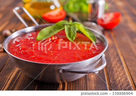 Tomato soup or gazpacho with ingredients on wooden table. Tomato soup or gazpacho with ingredients on wooden table. 138886904