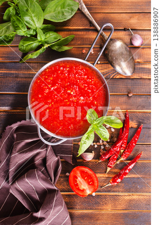 Tomato soup or gazpacho with ingredients on wooden table. 138886907