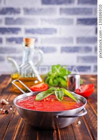 Tomato soup or gazpacho with ingredients on wooden table. Tomato soup or gazpacho with ingredients on wooden table. 138886910