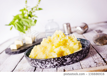 Mashed potatoes in bowl on a wooden background Mashed potatoes in bowl on a wooden background 138886916