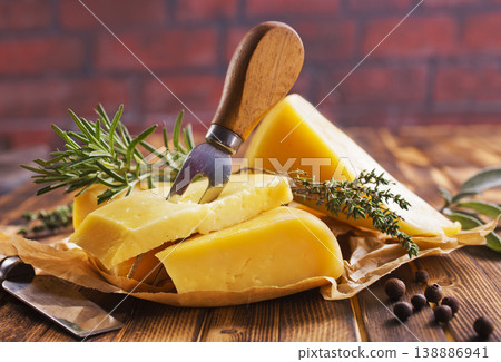 Plate with pieces of cheese and spice and rosemary 138886941