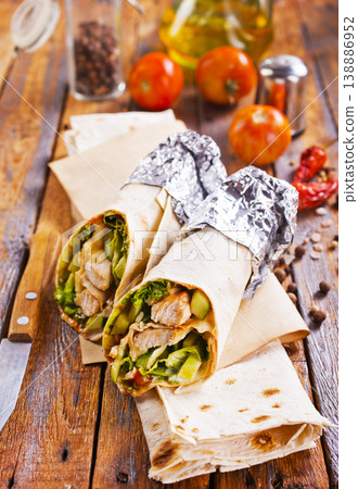 Tortilla wraps with chicken fillet and vegetables. Tortilla wraps with chicken fillet and vegetables. 138886952